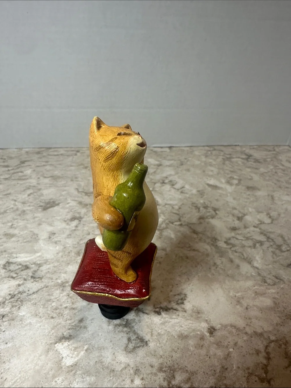 Yellow Cat Figurine Holding Bottle on Red Cushion- Bottle Stopper